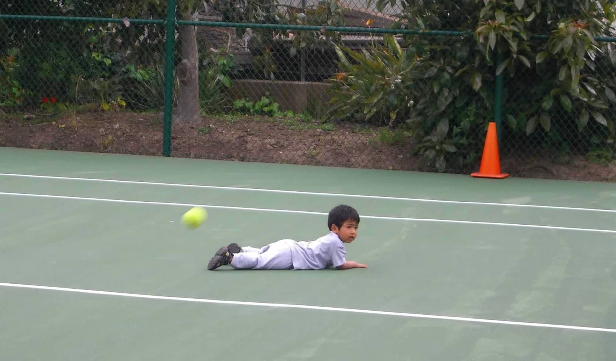 My brother playing tennis as a kid
